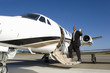 Businessman boarding aeroplane on runway