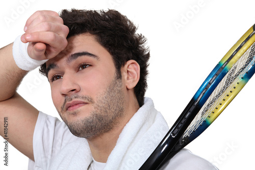 Photo: Tennis player wiping the sweat from his brow Tennis player wiping the sweat from his brow
