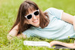 Beauty smiling woman reading book outdoor
