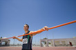 Photo: Male athlete with pole, low angle view (lens flare) Male athlete with pole, low angle view (lens flare)
