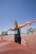 Photo: Male athlete resting arms on bar, low angle view Male athlete resting arms on bar, low angle view