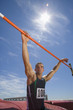 Photo: Young male athlete with hands on bar, low angle view (lens flare) Young male athlete with hands on bar, low angle view (lens flare)