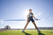 Photo: Male athlete with javelin, low angle view (lens flare) Male athlete with javelin, low angle view (lens flare)