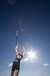 Photo: Male athlete throwing javelin, low angle view (lens flare) Male athlete throwing javelin, low angle view (lens flare)