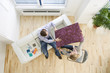 Couple looking at wallpaper sample in living room