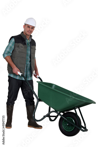 Photo: Construction worker with a wheelbarrow Construction worker with a wheelbarrow