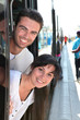Photo: Couple leaning out of tram Couple leaning out of tram