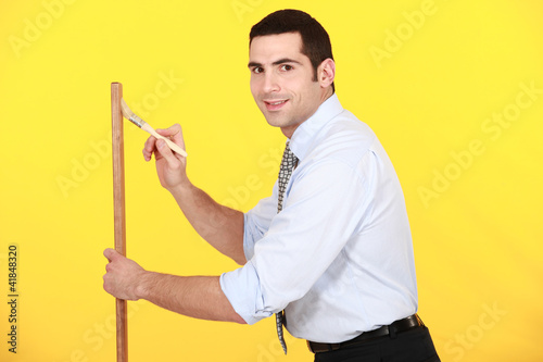 Photo: Office worker painting wood Office worker painting wood