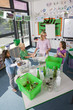 Teacher and students sorting recyclables in classroom