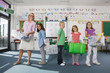 Teacher and students sorting recyclables in classroom together