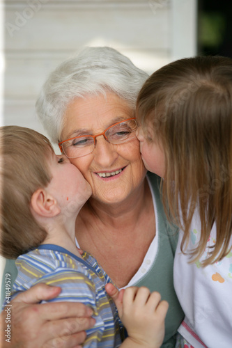 Photo: Grandchildren kissing grandma Grandchildren kissing grandma