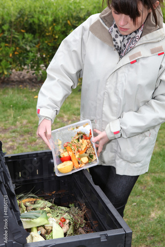 Photo: Woman making compost from old vegetables Woman making compost from old vegetables