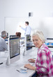 Smiling adult student studying in college evening class computer lab