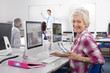Smiling adult student studying in college evening class computer lab