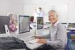 Smiling adult student studying in college evening class computer lab