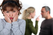 Little girl upset by parents arguing