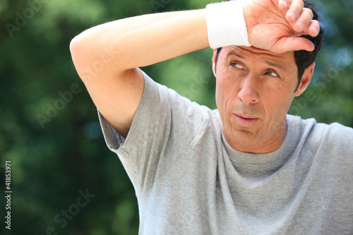 Photo: Man wiping sweat from his brow Man wiping sweat from his brow