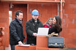 Parents and daughter visiting site of new house