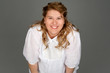Photo: smiling fat woman on gray background smiling fat woman on gray background