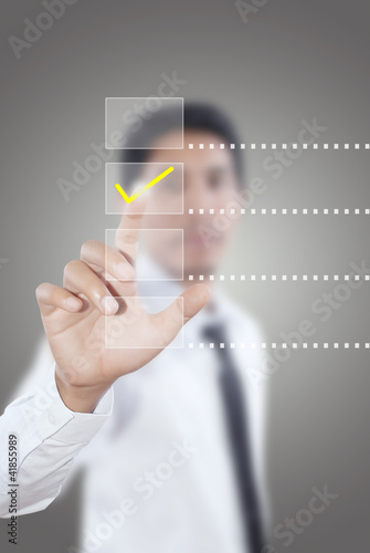 Photo: Businessman pushing correct choice. Businessman pushing correct choice.
