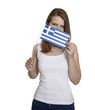 Attractive woman hides her face behind Greece flag