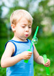 Boy inflates bubbles in the nature