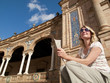 Tourist viewing ornate building in Plaza de Espana, Seville, Spain
