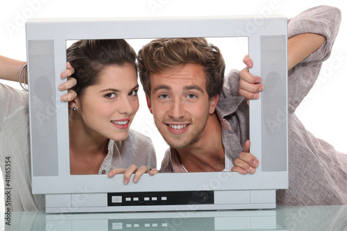Photo: Couple in an empty television screen Couple in an empty television screen