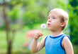 Boy with dandelion in nature