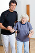 Photo: Trainer Assisting Woman With Walking Stick Trainer Assisting Woman With Walking Stick