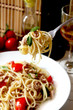 spaghetti with tuna fish and basil in a fork spaghetti with tuna fish and basil in a fork