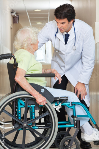 Photo: Doctor Communicating With Senior Woman Sitting In Wheelchair Doctor Communicating With Senior Woman Sitting In Wheelchair