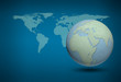World map and earth globes by cork board on blue background