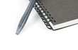 Book and pen on white isolated background