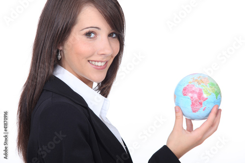 Photo: Young businesswoman with the world in her hands Young businesswoman with the world in her hands
