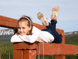 A girl lies on the balance beam and smiling