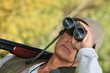 Hunter watching through binoculars
