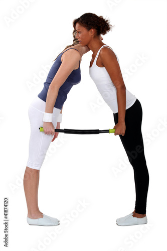 Photo: women doing exercises together women doing exercises together