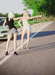 Two sexy blonde girls standing near broken car and hitchhiking Two sexy blonde girls standing near broken car and hitchhiking