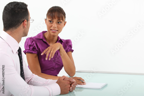 Photo: Businessman and woman in conversation Businessman and woman in conversation