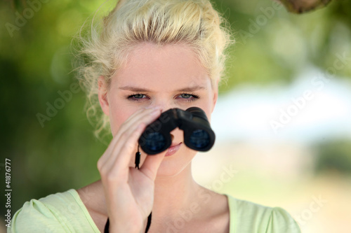 Photo: Woman with binoculars observing nature Woman with binoculars observing nature
