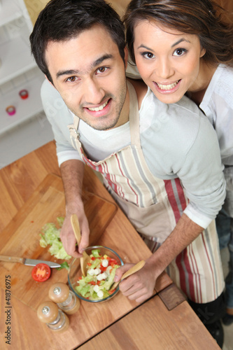 Photo: Top-view of couple making salad Top-view of couple making salad