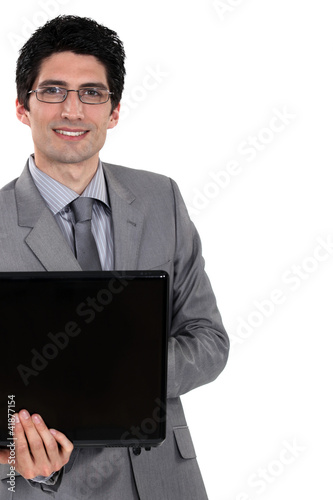 Foto: Cheerful businessman holding laptop computer Cheerful businessman holding laptop computer