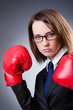 Young businesswoman in boxing concept