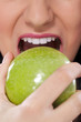 Woman eating a green apple