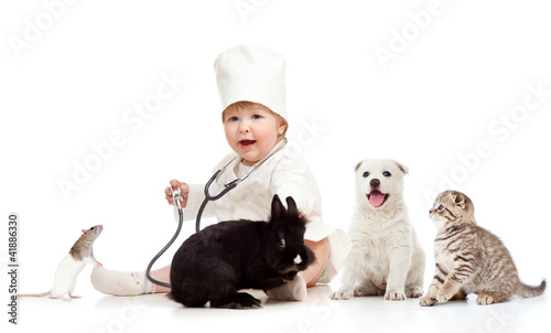Photo: Adorable small kid doctor examining pets dog, cat, bunny and rat Adorable small kid doctor examining pets dog, cat, bunny and rat