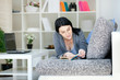 Women Reading a Book on Sofa Women Reading a Book on Sofa