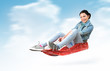 Foto: Young girl fly on a sled in the snow, concept winter driving Young girl fly on a sled in the snow, concept winter driving