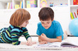 Young boys reading story book