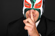 Masked man making a gesture to be silent.